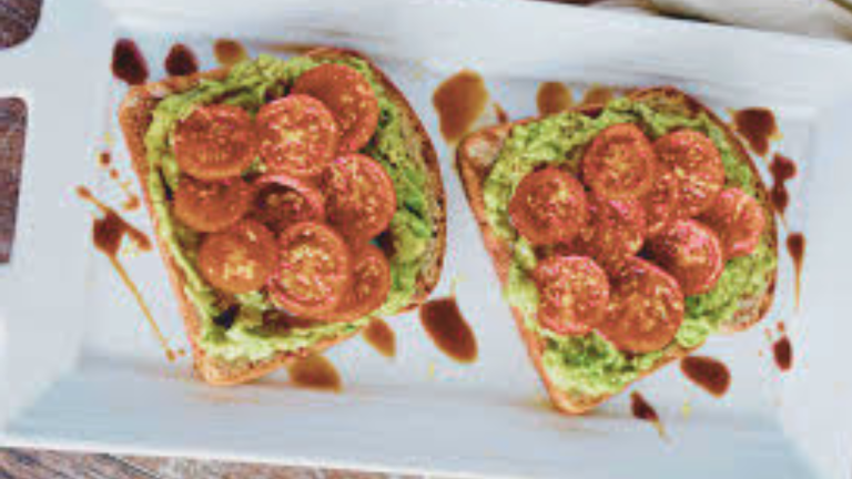 Avocado Toast on Whole Grain Bread with Cherry Tomatoes and Nutritional Yeast